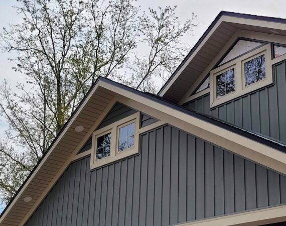 A house with two windows and a roof.