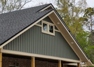 Here's a short alt tag for the image: `Gray board and batten siding on house`