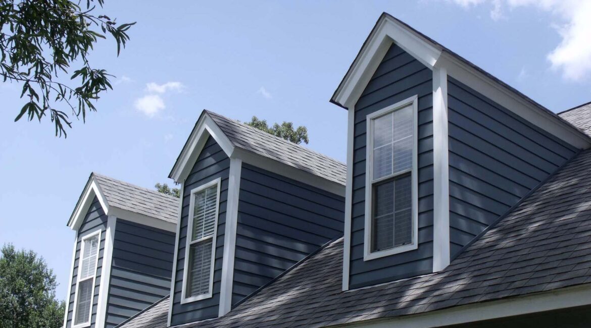 A blue house with two windows and a roof.