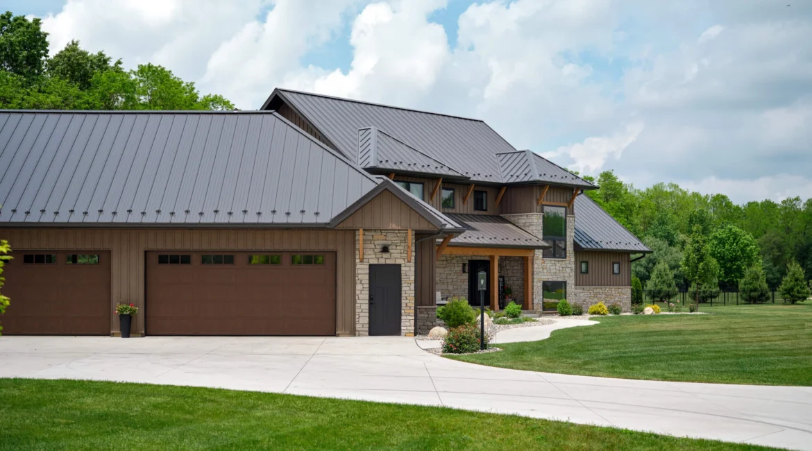 A large house with a driveway and lawn.