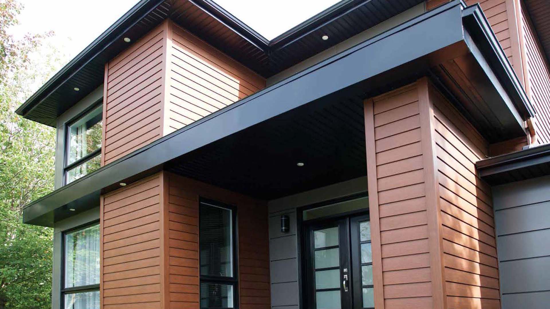 brown steel siding on home with black roof