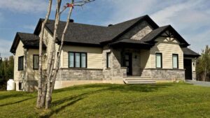 tan steel siding on home with black roof