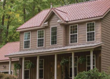 A brown house with red roof and windows