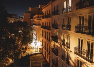 A building with many balconies at night.