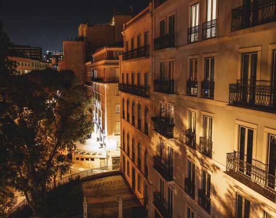 A building with many balconies at night.