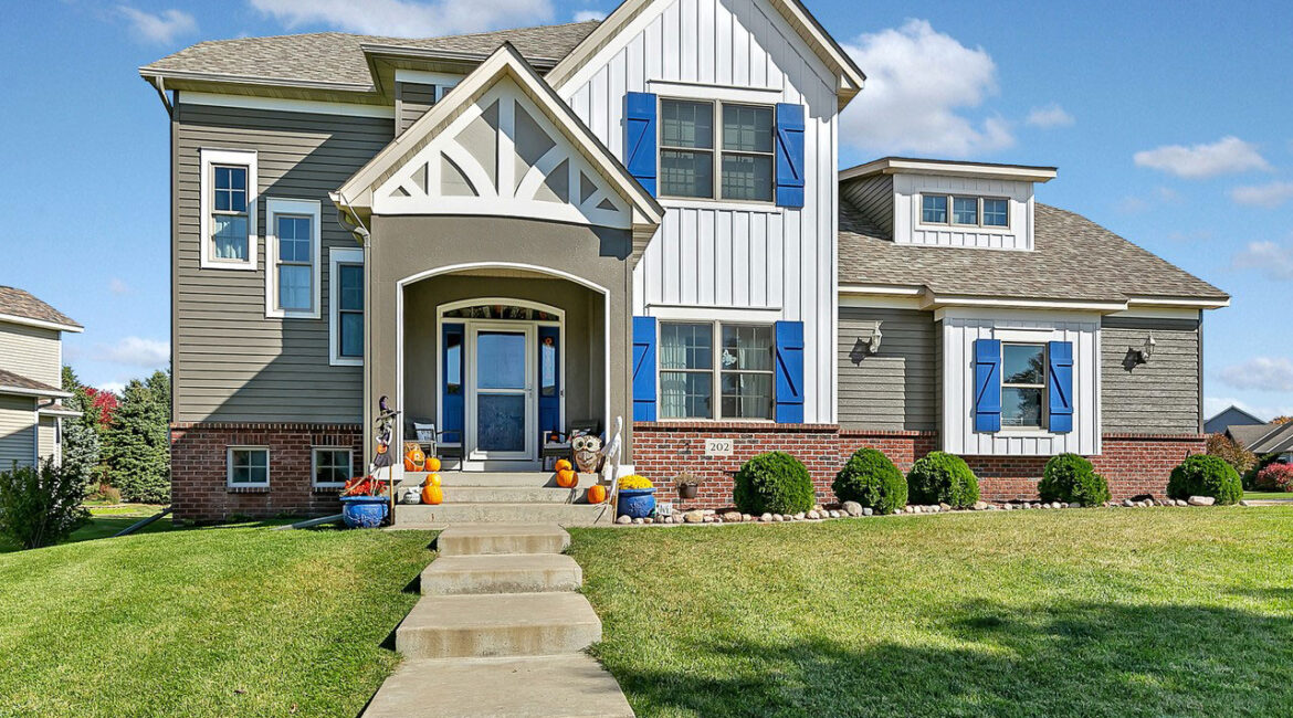 A house with blue shutters and steps leading to the front door.