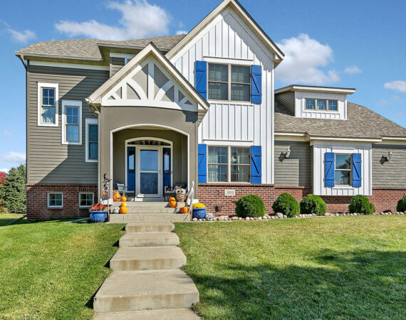 A house with blue shutters and steps leading to the front door.